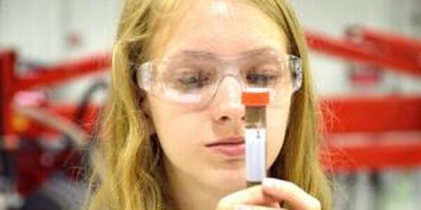 girl looking at test tube